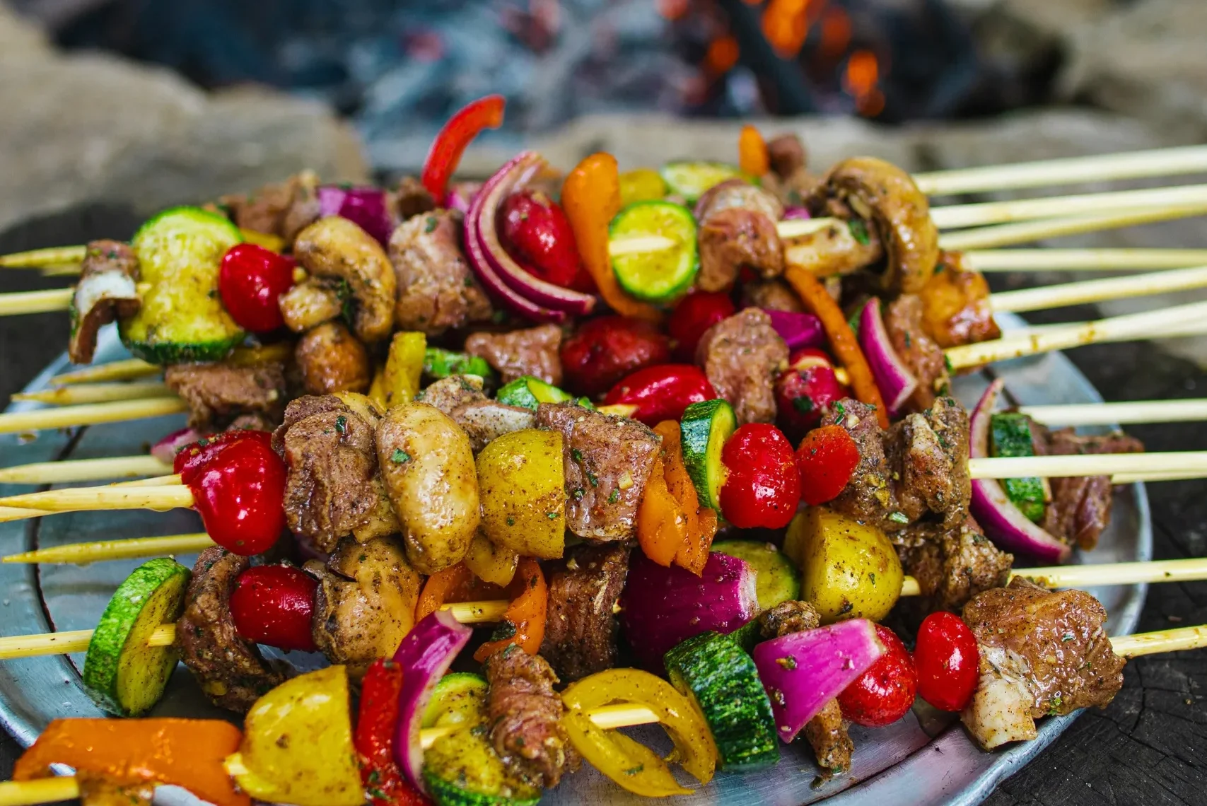 kabobs by a fire pit grill
