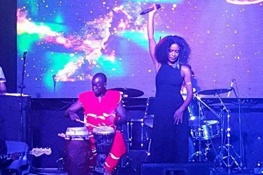 Melissa MoonChild on stage with african drummer